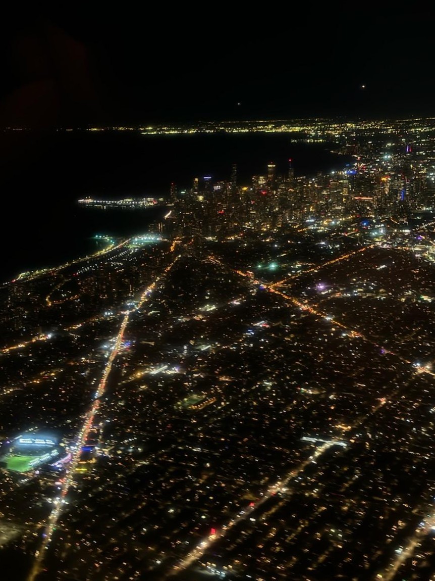 A view of Chicago at night from an airplane window.